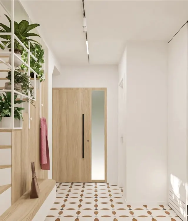 Entrance with wooden door, graphic tiles and plants
